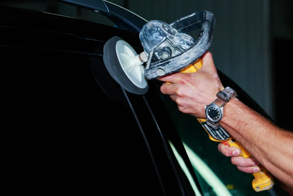 Expert paint correction on car using dual action polisher and polishing pad, removing defects for flawless ceramic coating base, Staten Island auto detailing service